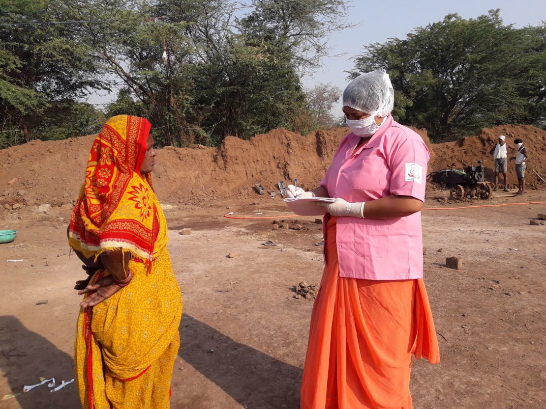 Rohini Pawar notes down the details of a brick kiln worker in Walhe, India.