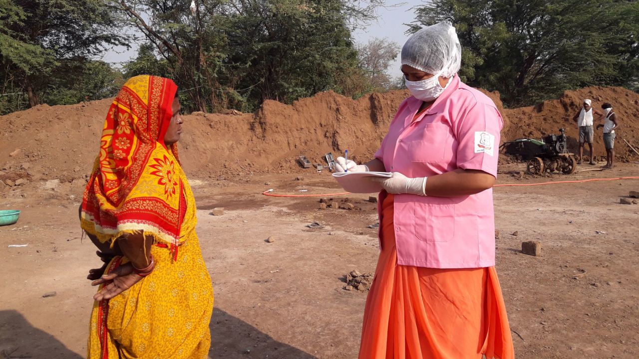 Rohini Pawar notes down the details of a brick kiln worker in Walhe, India.