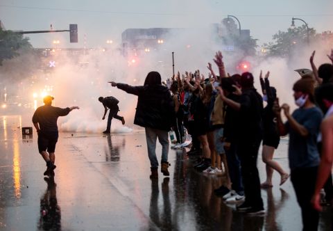 Tear gas is fired as protesters clash with police in Minneapolis on May 26.