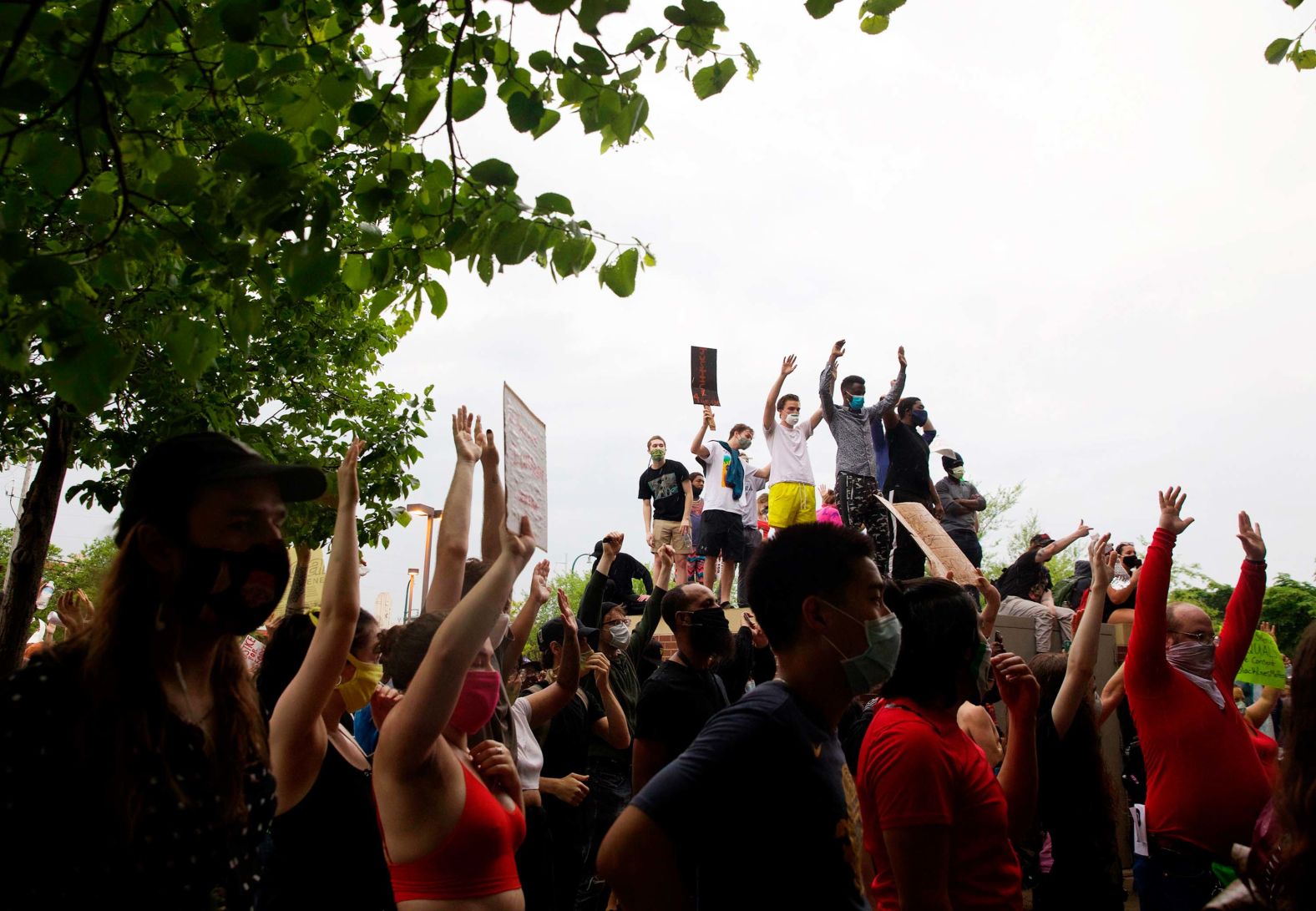 People stand outside the Minneapolis Police Third Precinct and chant "Hands up, don't shoot" on May 26.