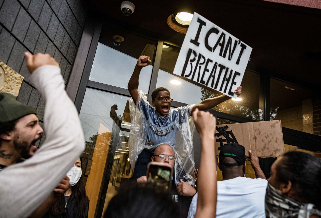 People gather outside a police precinct during demonstrations in Minneapolis on May 26.