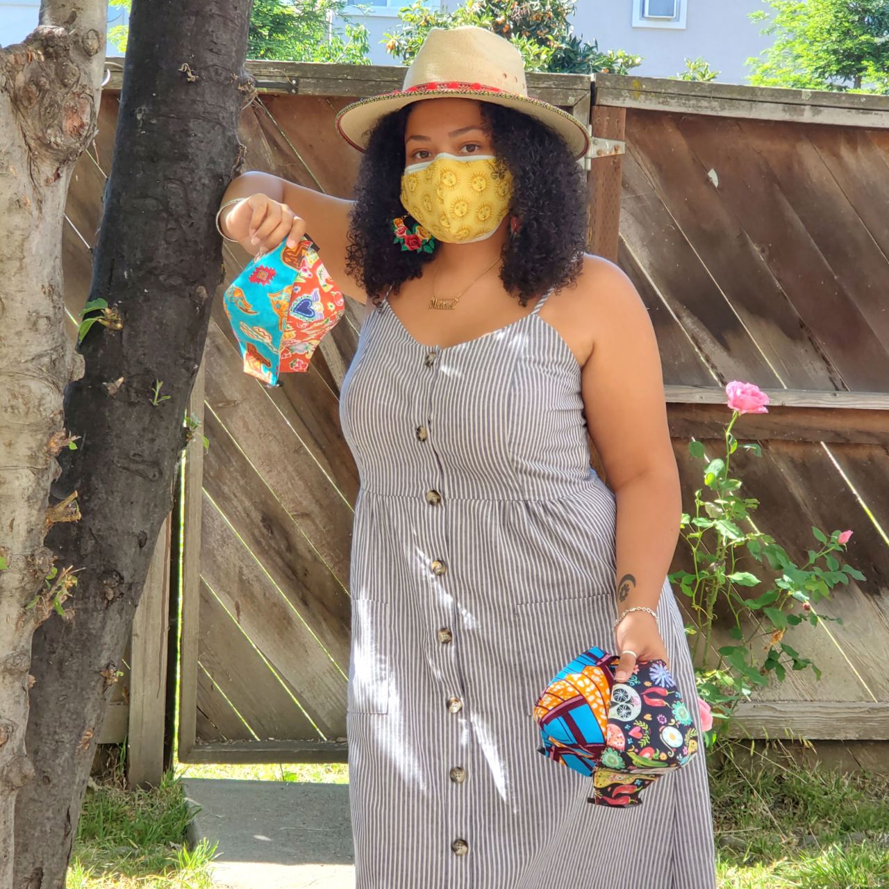 Marisol Catchings wearing and holding her face masks.
