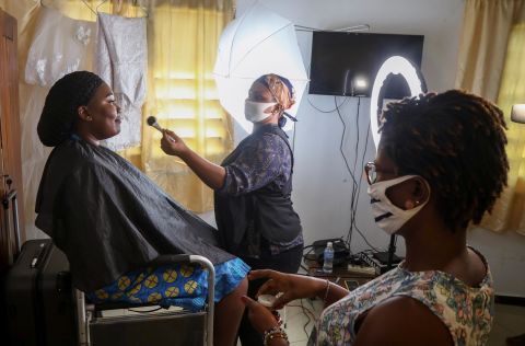 Make-up artists wear face masks while preparing Marie Andrea Offoumou for her wedding in Abidjan, Ivory Coast, on May 15.