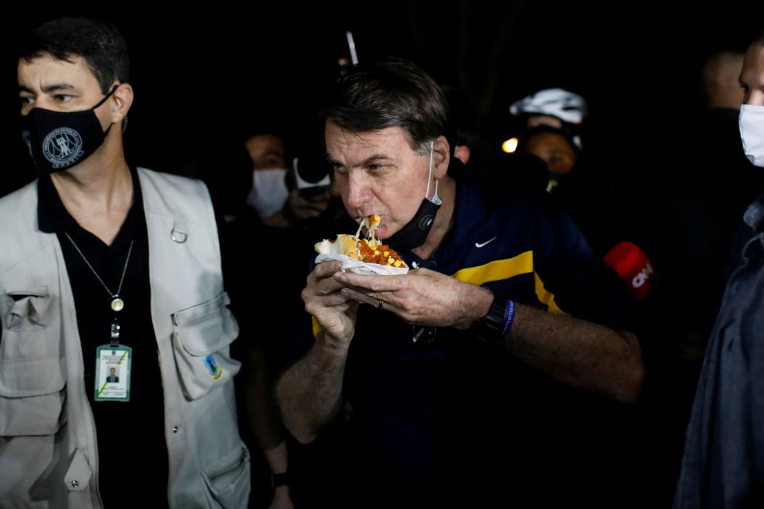 Bolsonaro was met with angry protestors when eating a hotdog in Brasilia.