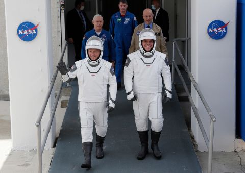 Hurley and Behnken walk out of the Neil Armstrong Operations and Checkout Building.