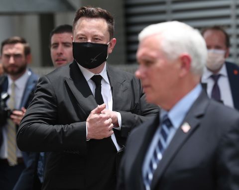 SpaceX founder <a href="https://www.cnn.com/2020/05/13/us/gallery/elon-musk/index.html" target="_blank">Elon Musk</a> wears a face mask while standing near Vice President Mike Pence.