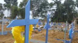 Workers have made hundreds of crosses to mark new graves at the Parque Taruma Cemetery.