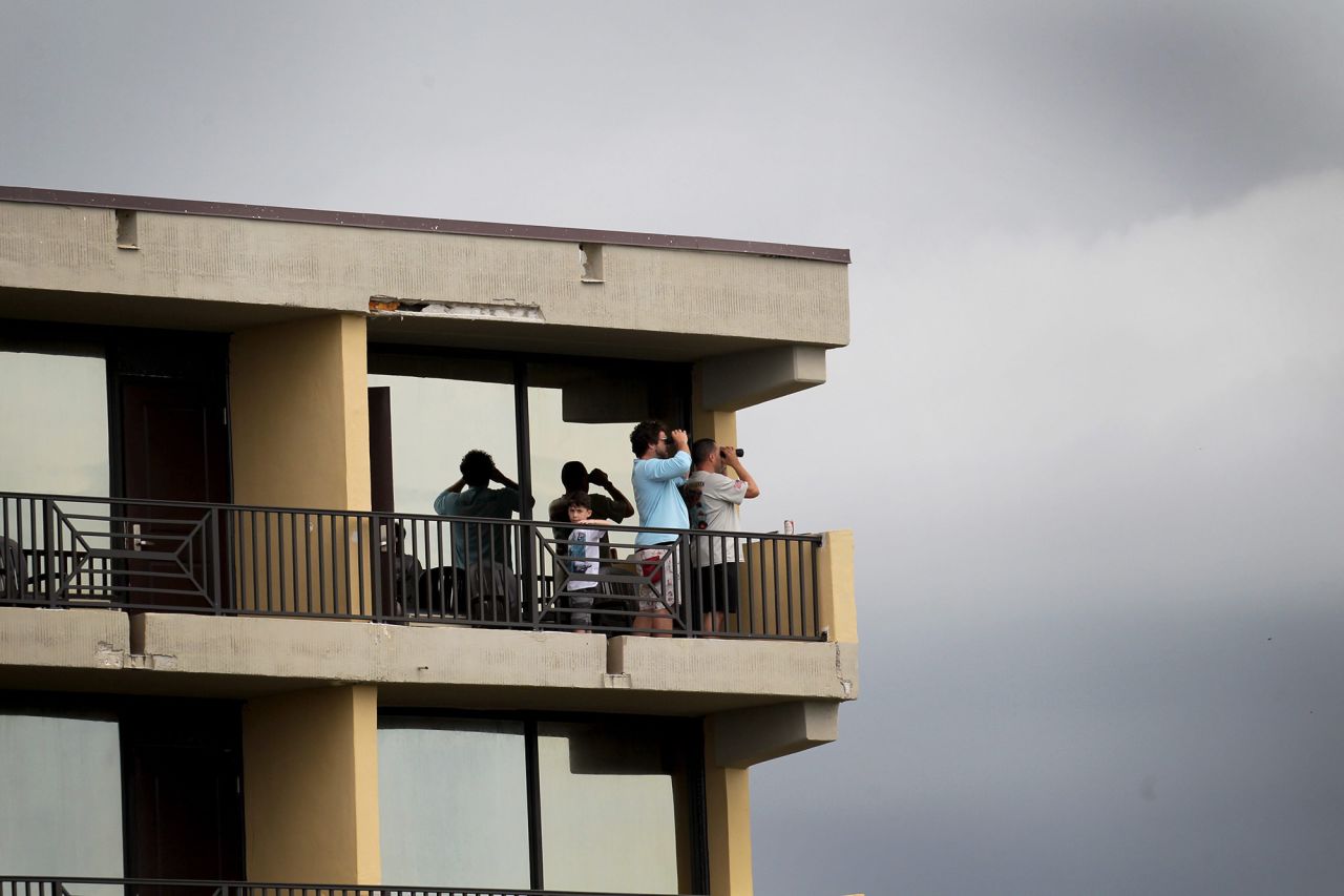 Spectators look out from a hotel balcony in Cocoa Beach, Florida, on May 27.