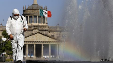 A worker wearing a protective suit sprays disinfectant during a campaign to sanitize public spaces in Guadalajara, Mexico, on March 20.