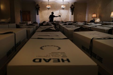 Omar Rodriguez organizes caskets at the Gerard Neufeld Funeral Home in New York. The funeral home in Queens was overwhelmed by the pandemic.