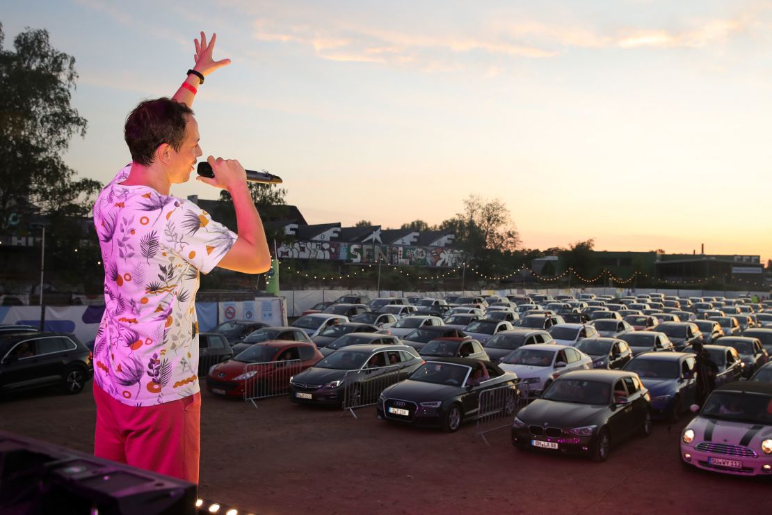 Drive-in events have expanded beyond movies to live music and theater. Here, 200 cars line up to see German DJ Alle Farben perform in Bonn, Germany. 