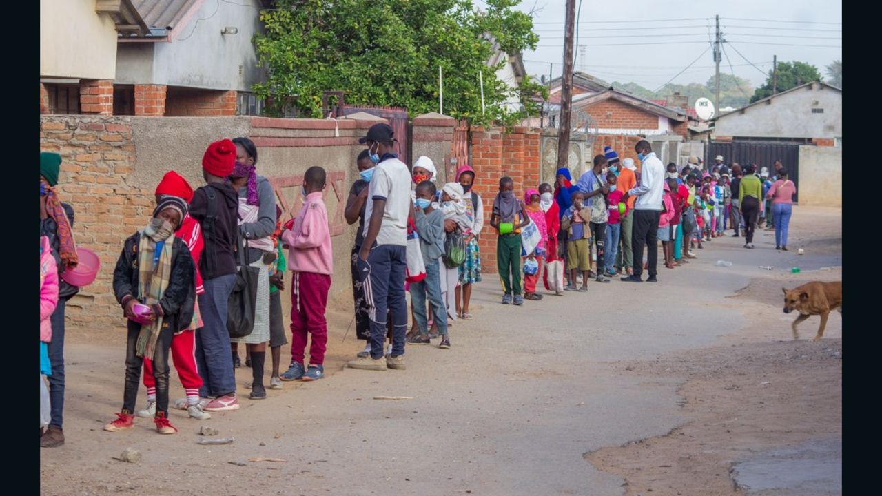 Children queue for food outside Murozoki's kitchen in Zimbabwe. 