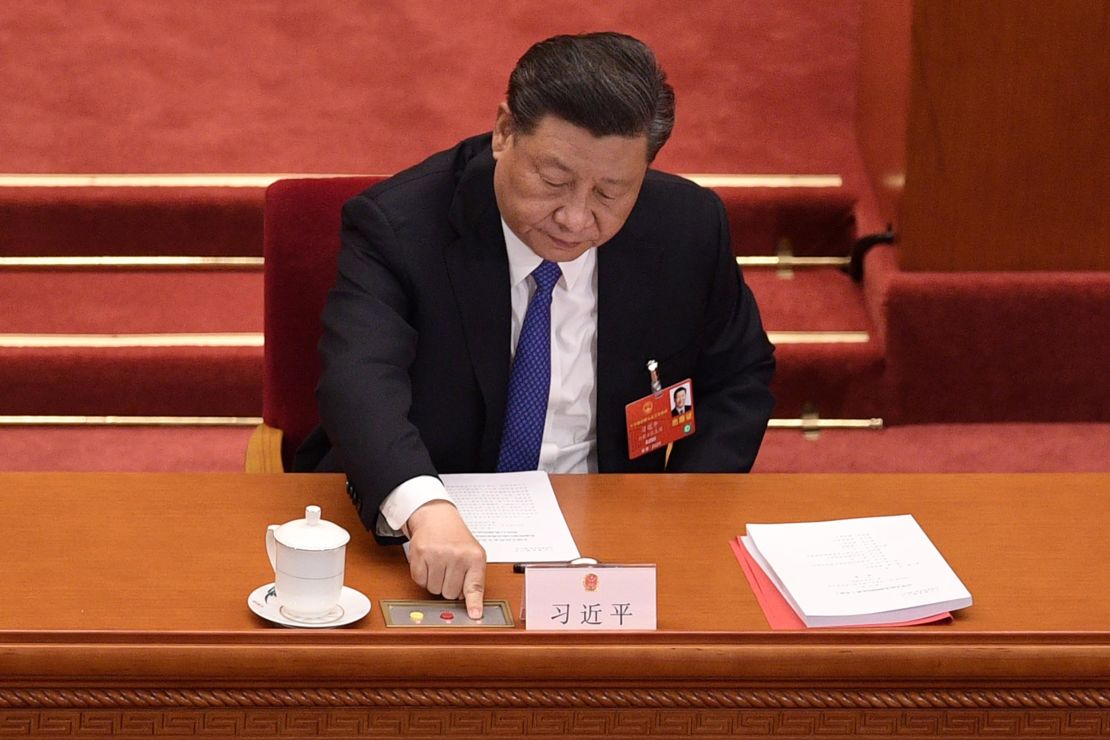 Chinese President Xi Jinping votes on a proposal to draft a security law on Hong Kong during the closing session of the National People's Congress at the Great Hall of the People in Beijing on May 28, 2020. 