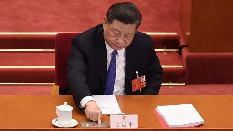 Chinese President Xi Jinping votes on a proposal to draft a security law on Hong Kong during the closing session of the National People's Congress at the Great Hall of the People in Beijing on May 28, 2020. 