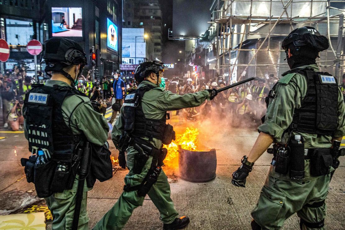 Police stand guard on a road to deter pro-democracy protesters from blocking roads in the Mong Kok district of Hong Kong on May 27, 2020.