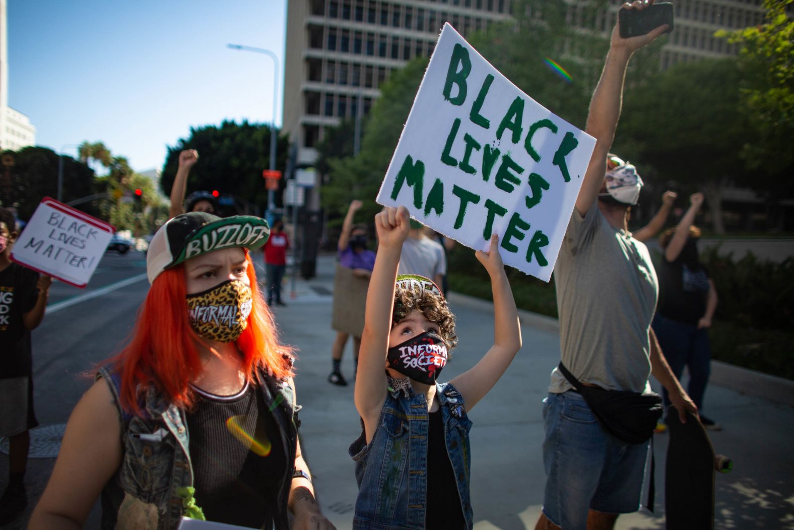 Kika Villareal, left, and her daughter Aubrie march with fellow protesters in Los Angeles on May 27.