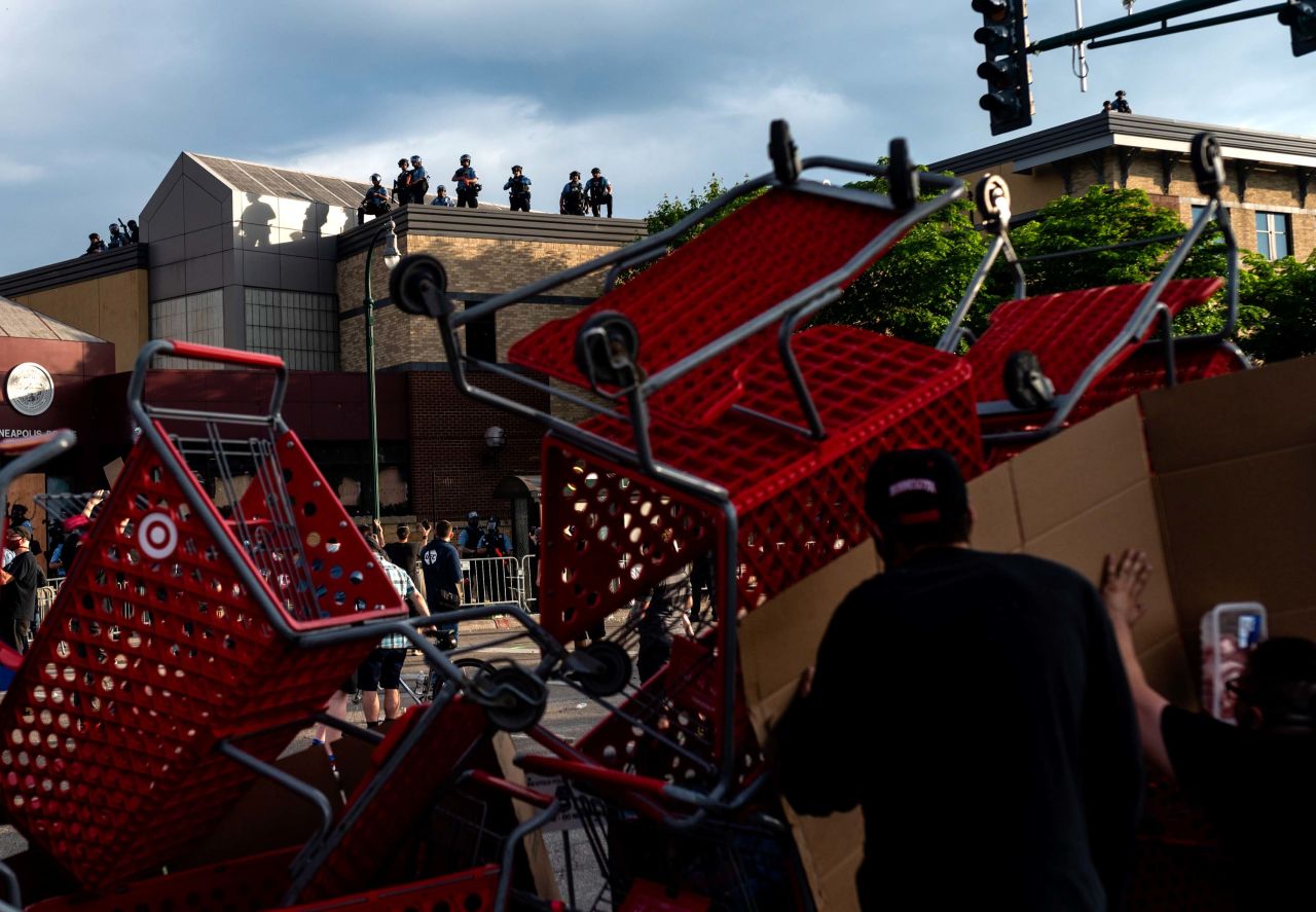 Protesters use shopping carts as a barricade as they confront police near a Minneapolis police precinct on May 27.