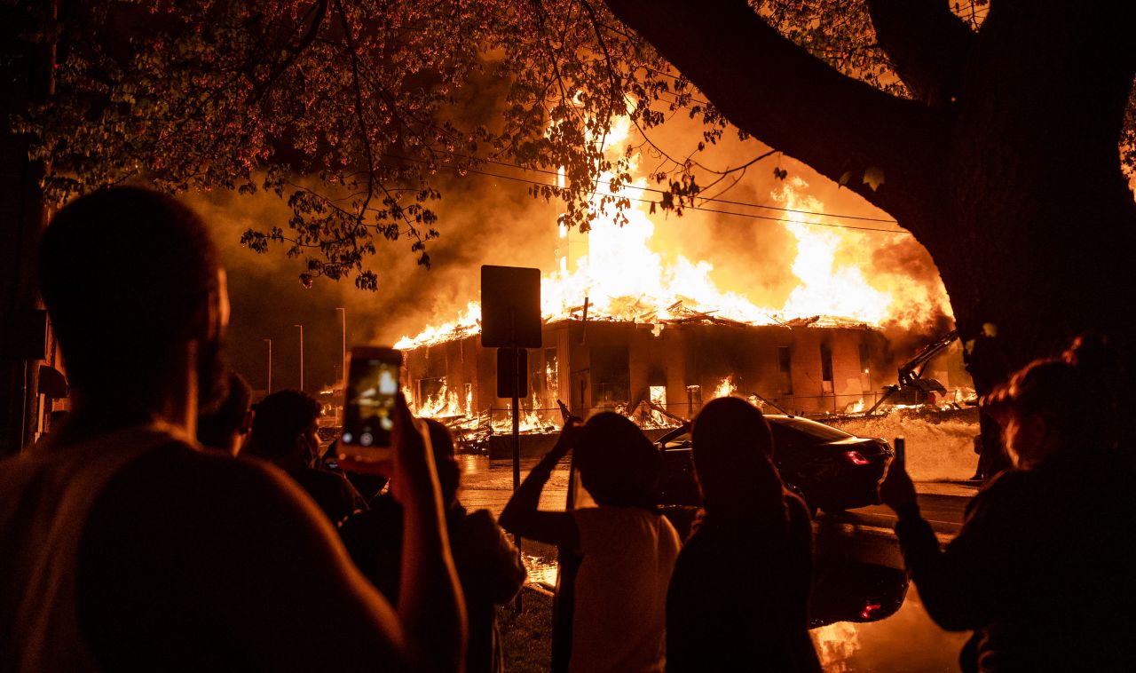 People look on as a construction site burns in Minneapolis on May 27.