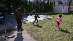 MOUNT VERNON, NY - MARCH 26: Mo Major plays in the back yard with his children Max, 5, and Marley, 4, on March 26, 2020 in Mount Vernon, New York. Mo was laid off as a chef consultant and his wife furloughed as a pre-school teacher when businesses and schools closed due to the coronavirus pandemic. The family left their apartment in New Rochelle, NY, hard hit by  COVID-19, to live temporarily with Geri's parents who have a larger home in nearby Mount Vernon. (Photo by John Moore/Getty Images)