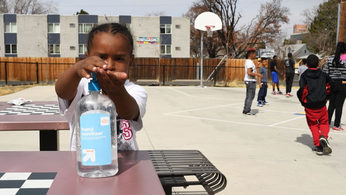 Messiah Guyton, 4, puts on hand sanitizer before eating his snack in Aurora, Colorado.