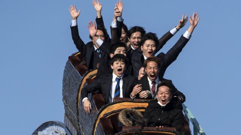 Theme parks in Japan have issued guidelines suggesting visitors keep quiet and wear masks while on rides, making scenes like this a thing of the past. 