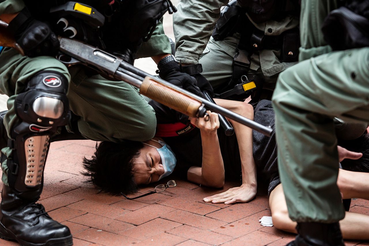 A pro-democracy protester is detained by police on May 24.