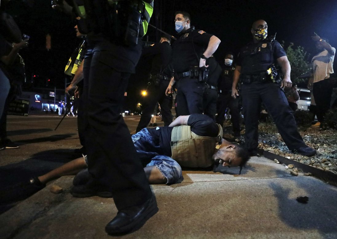 A protester in Memphis, Tennessee, winces in pain after being hit with pepper spray by police on Thursday, May 28.