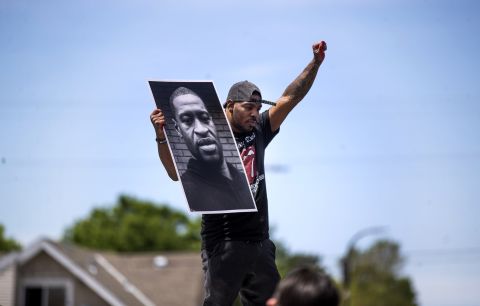 Tony L. Clark holds up a poster of George Floyd during a protest in Minneapolis on May 28.