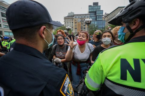 Protesters speak to police officers during a demonstration in New York City on May 28.