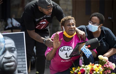 Gwen Dumas is consoled near a convenience store in Minneapolis on May 28.