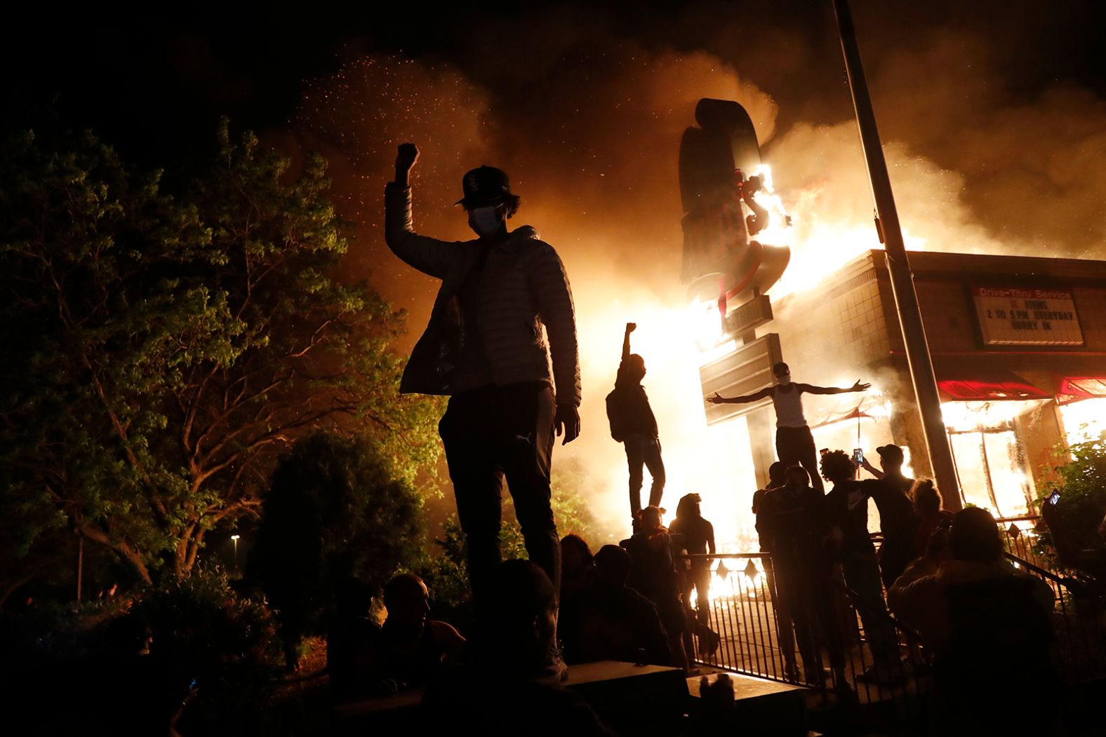 Protesters gather in front of a burning fast-food restaurant in Minneapolis on May 29.