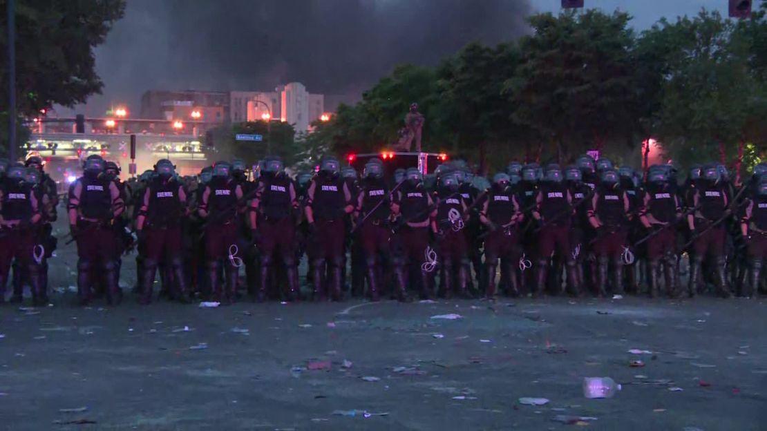 Minneapolis Police and Minnesota State Patrol form a police line.