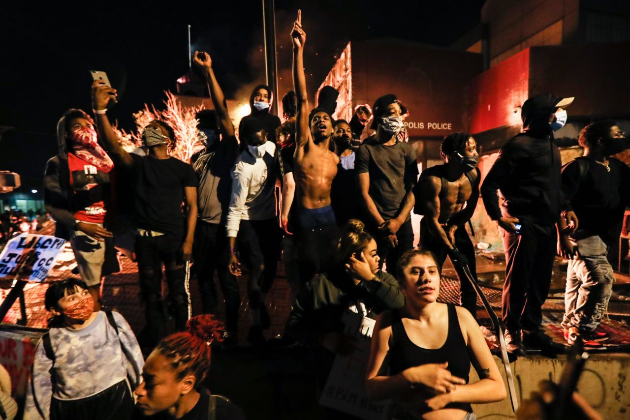 People demonstrate outside of a burning Minneapolis police precinct on May 28.