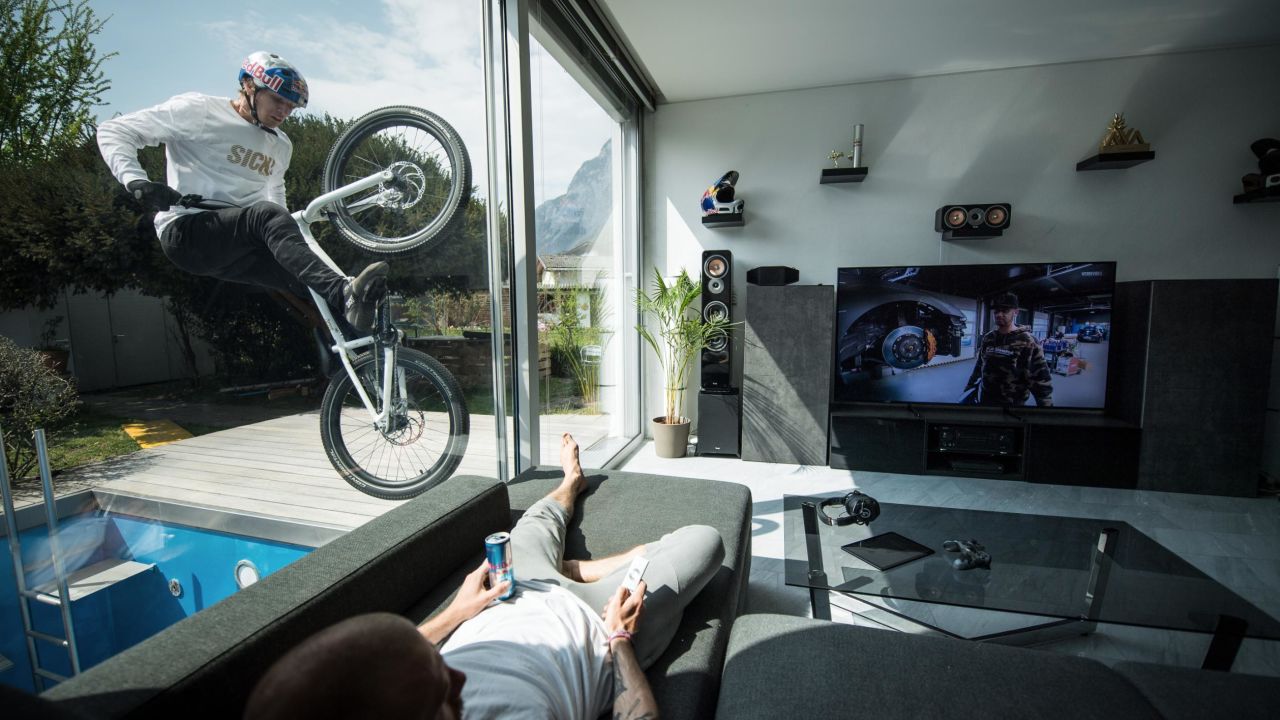 Wibmer balances on the outside of a window of his house.