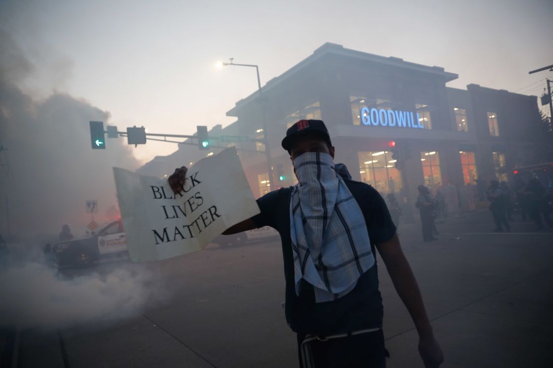 A demonstrator displays a "Black Lives Matter" sign Thursday, May 28, 2020, in St. Paul, Minnesota.