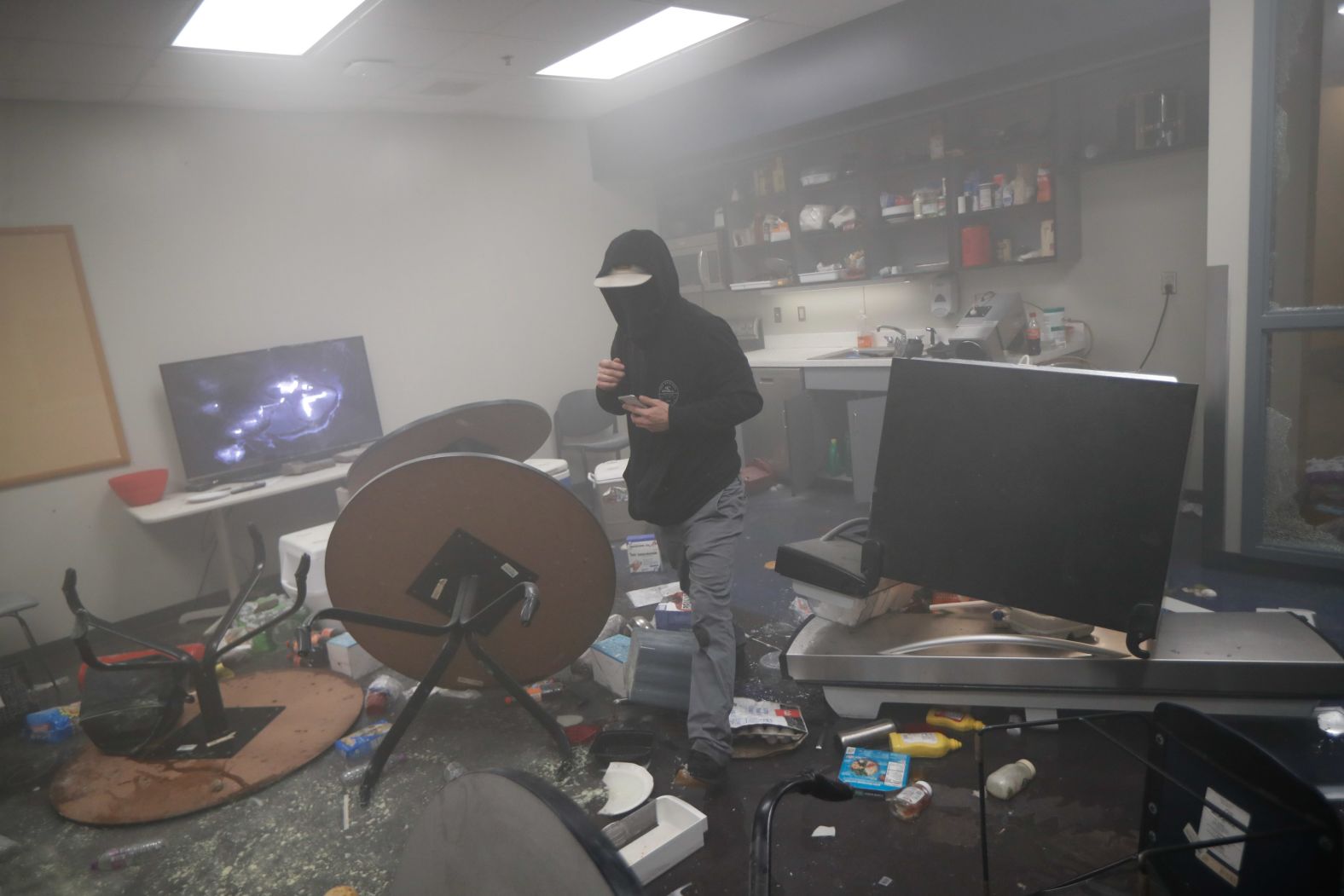 A protester moves around a smoke-filled police precinct in Minneapolis on May 28.