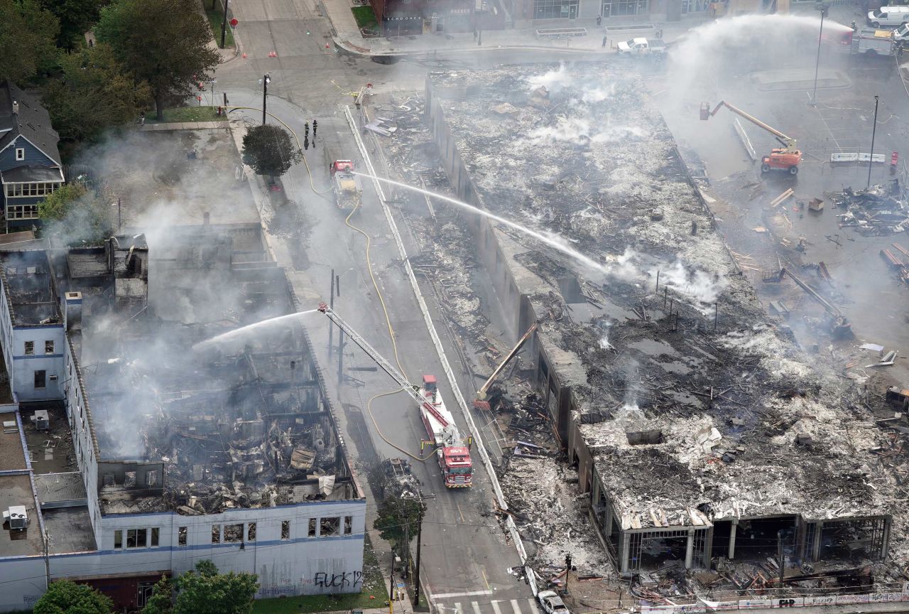 Crews work to put out fires after an apartment building under construction was burned to the ground during protests in Minneapolis on May 28.