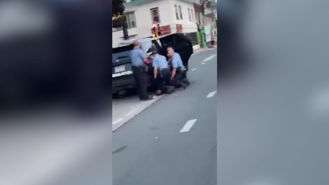 A screengrab from the new video, appearing to show three officers kneeling on George Floyd.