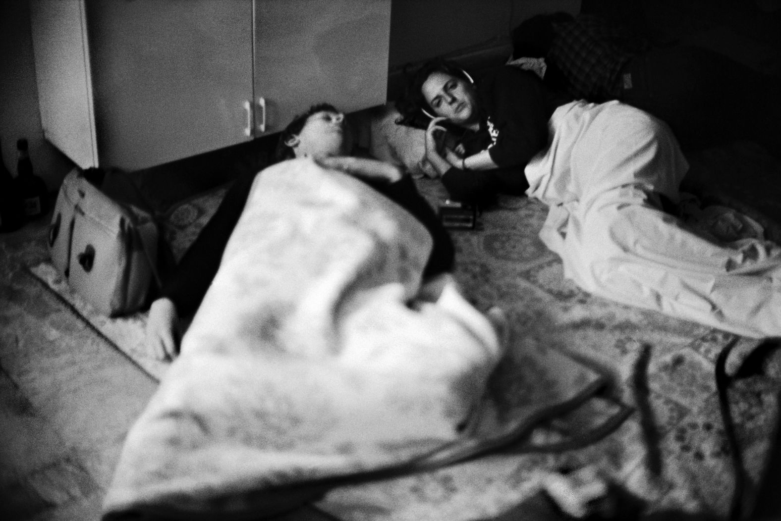 In 1984, CNN camerawomen sleep on a hotel floor while their producer stays awake during rocket attacks in West Beirut, Lebanon.