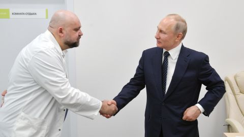 Russian President Vladimir Putin, right, shaking hands with Denis Protsenko, the head of a new hospital treating coronavirus patients in Moscow on March 24.