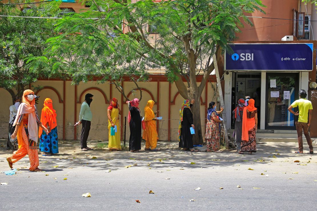 People wait outside a bank during lockdown in Jaipur, Rajasthan, India, on April 9.