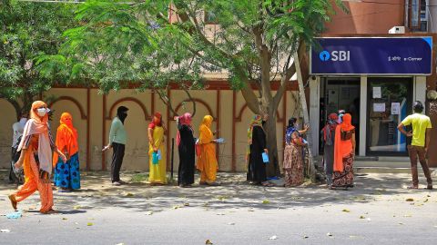 People wait outside a bank during lockdown in Jaipur, Rajasthan, India, on April 9.