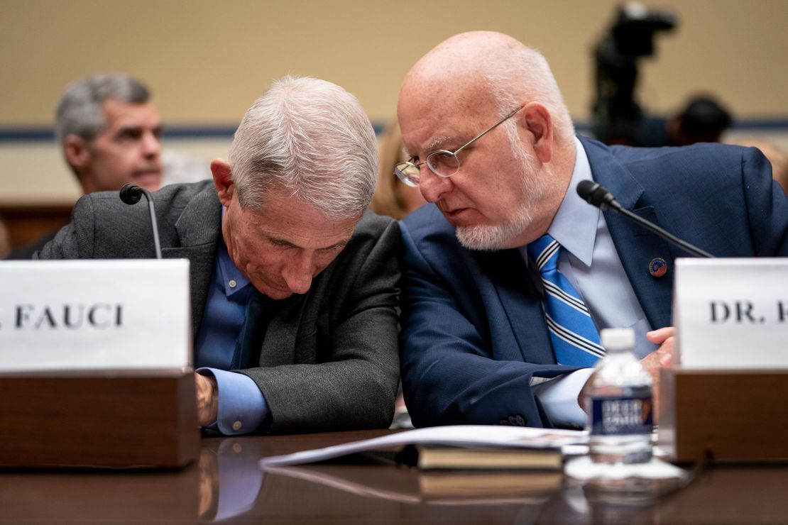 Dr. Robert Redfield confers with Dr. Anthony Fauci during a House Oversight And Reform Committee hearing on the coronavirus on March 11, 2020. 