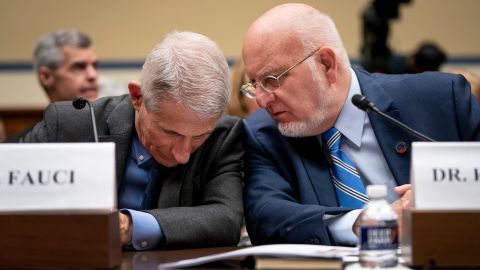 Dr. Robert Redfield confers with Dr. Anthony Fauci during a House Oversight And Reform Committee hearing on the coronavirus on March 11, 2020.