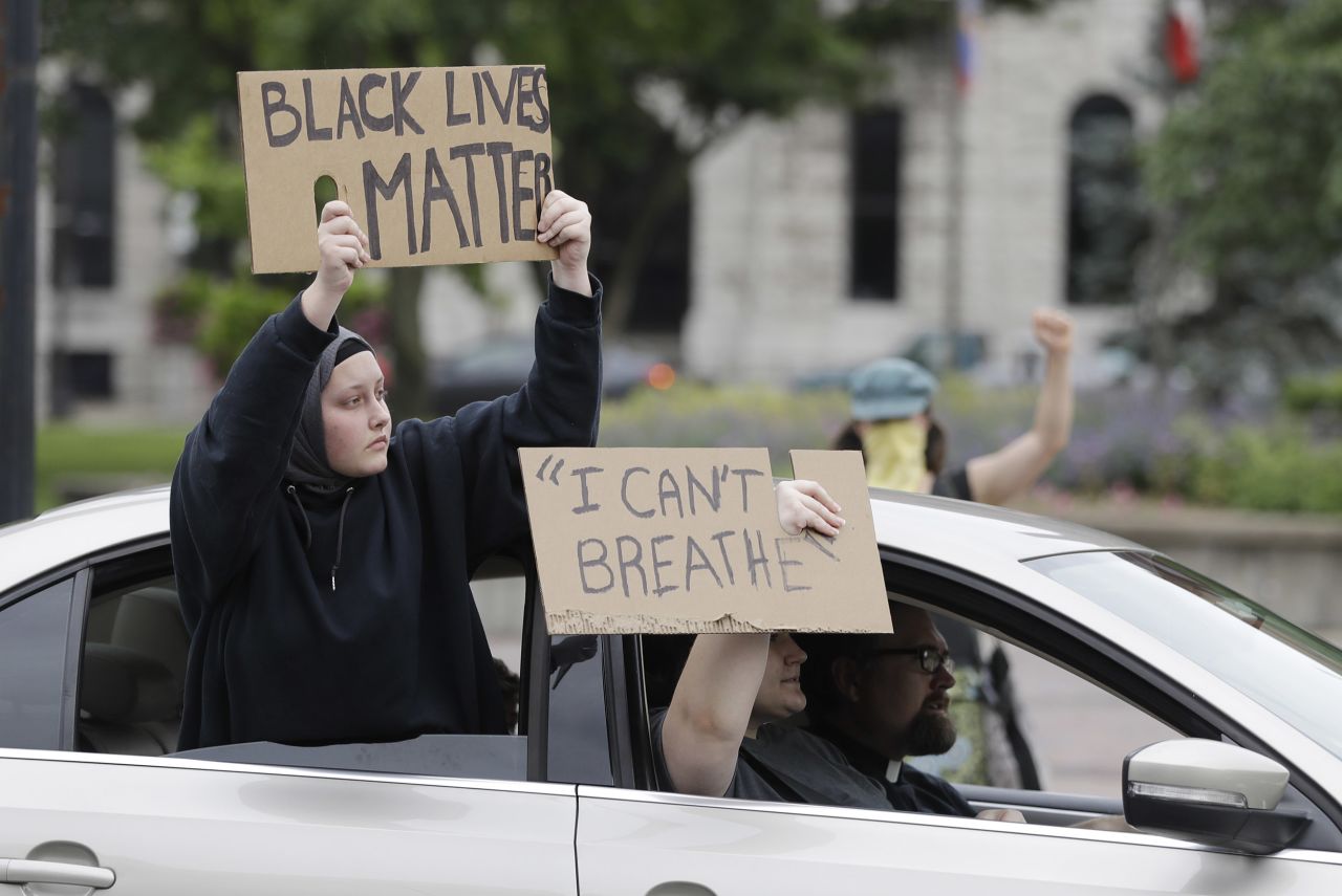 Protesters ride in cars during a demonstration in Louisville, Kentucky, on May 29.