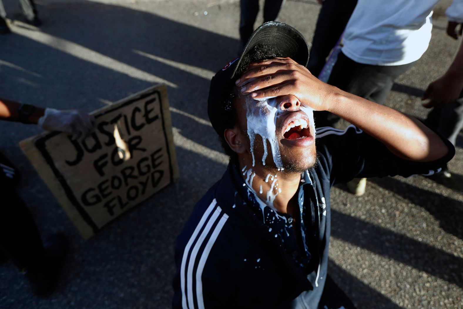 A protester in Minneapolis douses himself with milk on May 29.