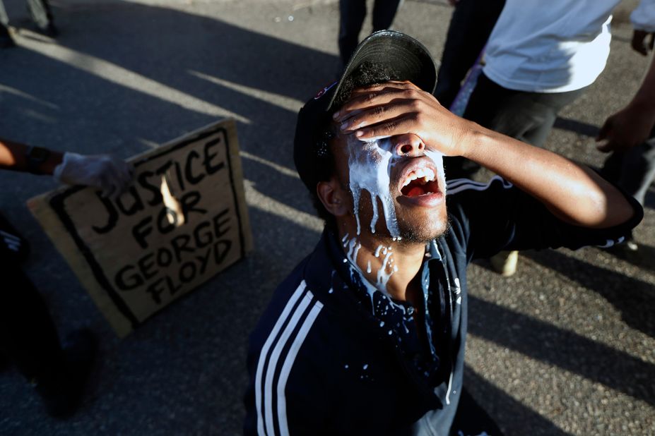 A protester in Minneapolis douses himself with milk on May 29.