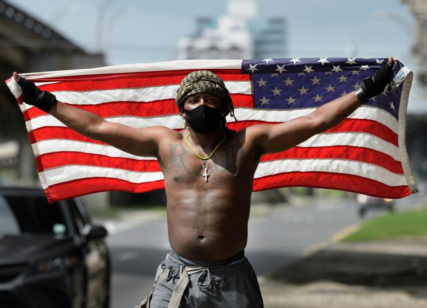 A protester holds up an American flag in New Orleans on May 29. 