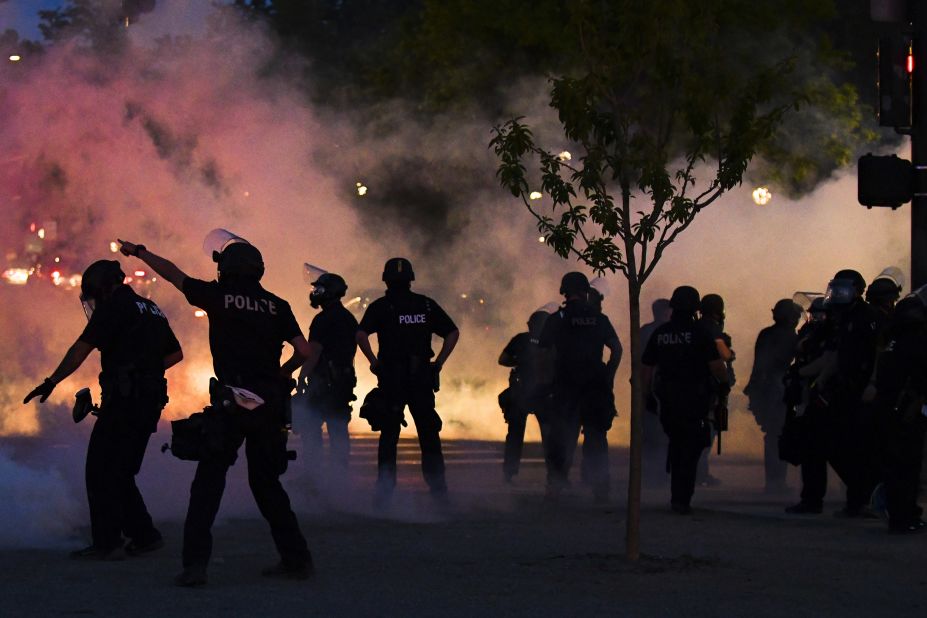 Police officers fire tear gas at protesters in Denver on May 29.