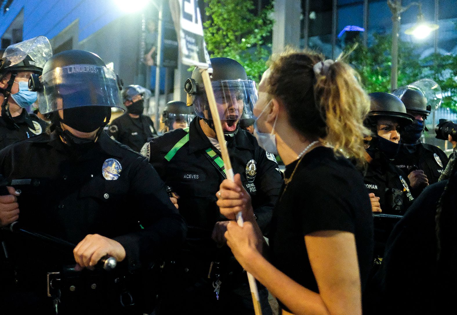 Police officers move forward to clear a street during a protest in downtown Los Angeles on May 29.